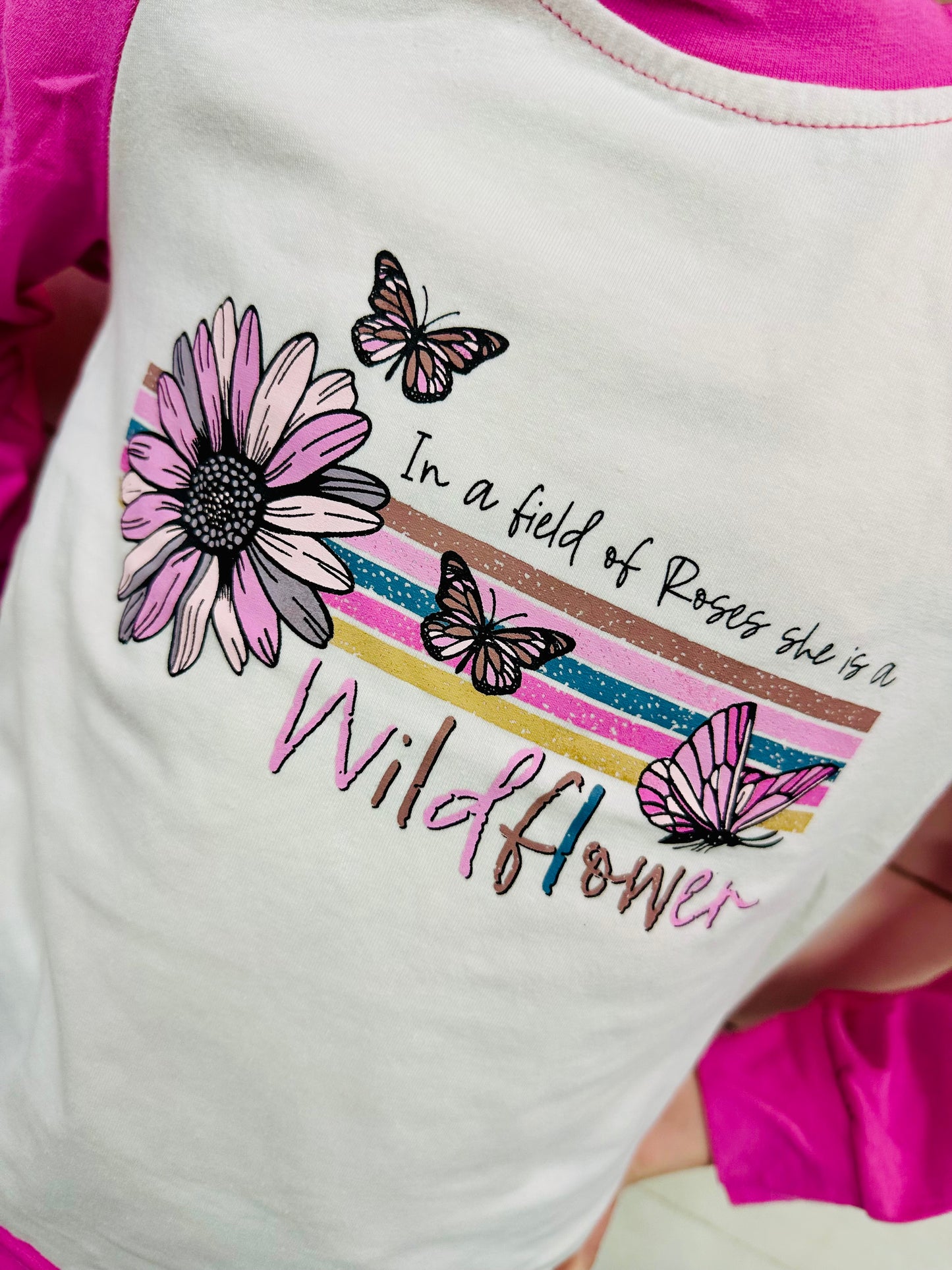 “In a Field of Roses, She is a Wildflower” Onesie